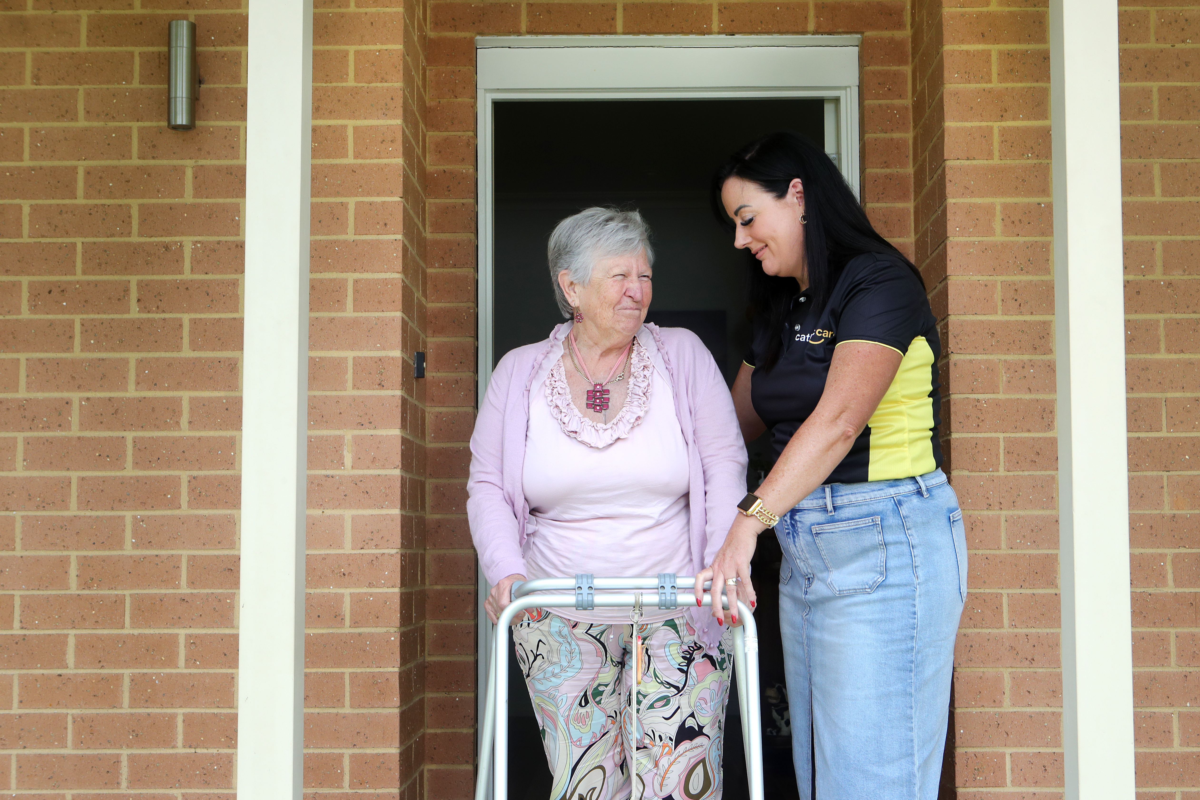 CSW Assisting NDIS Client With Walking Frame